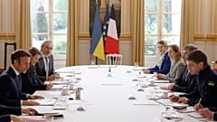 French President Emmanuel Macron, left, speaks with mayor of the Ukrainian city of Melitopol, Ivan Fedorov, right, during a meeting at the Elysee Palace, in Paris, 1/4/2022.