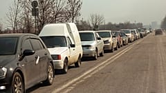 Local residents lineup in their cars to leave Mariupol, March 24, 2022.