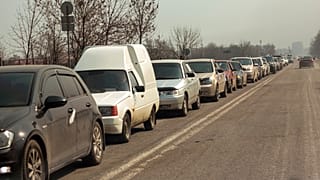 Local residents lineup in their cars to leave Mariupol, March 24, 2022.