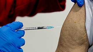 File photo shows a 87-year-old man getting his booster shot at the vaccination center in Frankfurt, Germany, Thursday, Nov. 11, 2021.