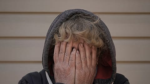 Natalya, whose husband and nephew were killed by Russian forces, cries in her garden in Bucha, Ukraine, Monday, April 4, 2022.