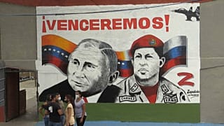 A smiling Vladimir Putin next to the deceased Hugo Chavez and a 'Z' for 'victory' are painted in a Caracas neighbourhood.