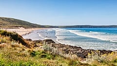 A beach in Devon, south-east England, on a sunny day.