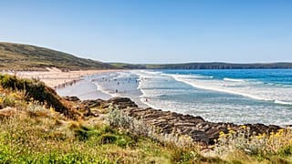 A beach in Devon, south-east England, on a sunny day.
