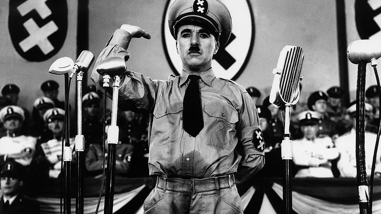 Charlie Chaplin, whose parents were both half-Romani, caricatures Adolf Hitler in The Great Dictator (1940)
