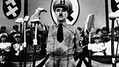 Charlie Chaplin, whose parents were both half-Romani, caricatures Adolf Hitler in The Great Dictator (1940)