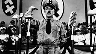 Charlie Chaplin, whose parents were both half-Romani, caricatures Adolf Hitler in The Great Dictator (1940)