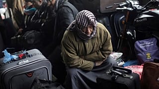 فلسطينيون يجلسون بجانب أمتعتهم أثناء انتظارهم للعبور إلى الجانب المصري من معبر رفح الحدودي مع مصر، في جنوب قطاع غزة، السبت 28 يناير 2017