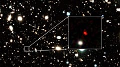 The distant early galaxy HD1, object in red, is shown at the center of this undated zoom-in handout image.