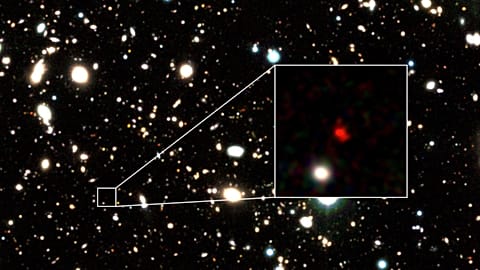 The distant early galaxy HD1, object in red, is shown at the center of this undated zoom-in handout image.