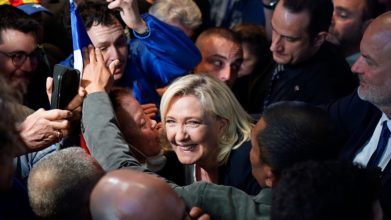 French far-right leader Marine Le Pen smiles to supporters during a campaign rally in Perpignan, southern France, Thursday, April 7, 2022.