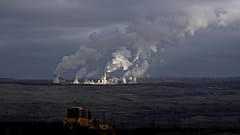 Steam and smoke rise from power plant located by the Turow lignite coal mine near the town of Bogatynia, Poland.