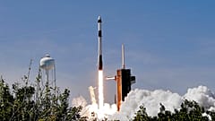 A SpaceX Falcon 9 rocket with the Crew Dragon capsule attached, lifts off with the first private crew from Launch Complex 39