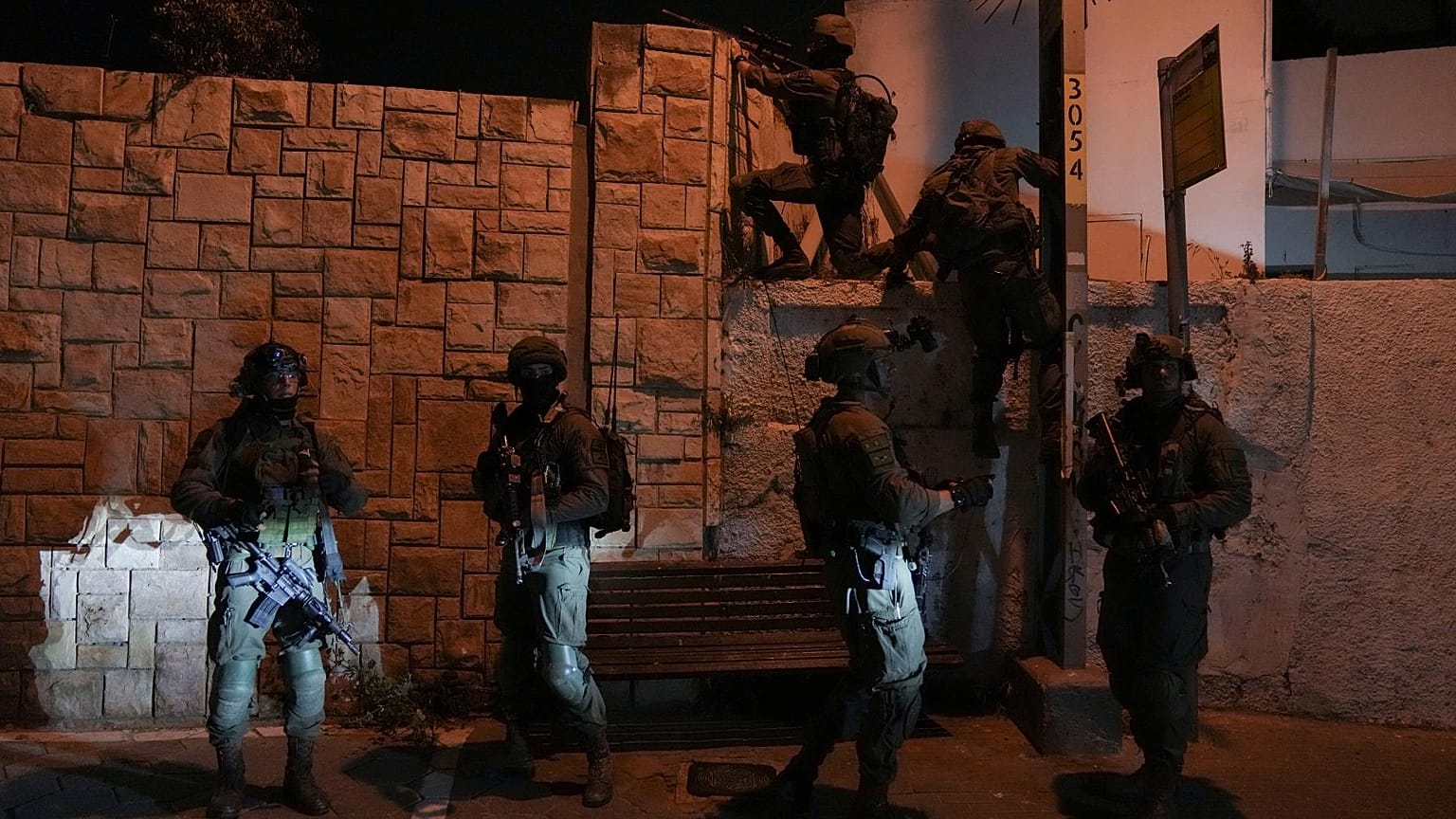 Israeli security forces search for assailants near the scene of a shooting attack in Tel Aviv, Israel, Thursday, April 7, 2022.
