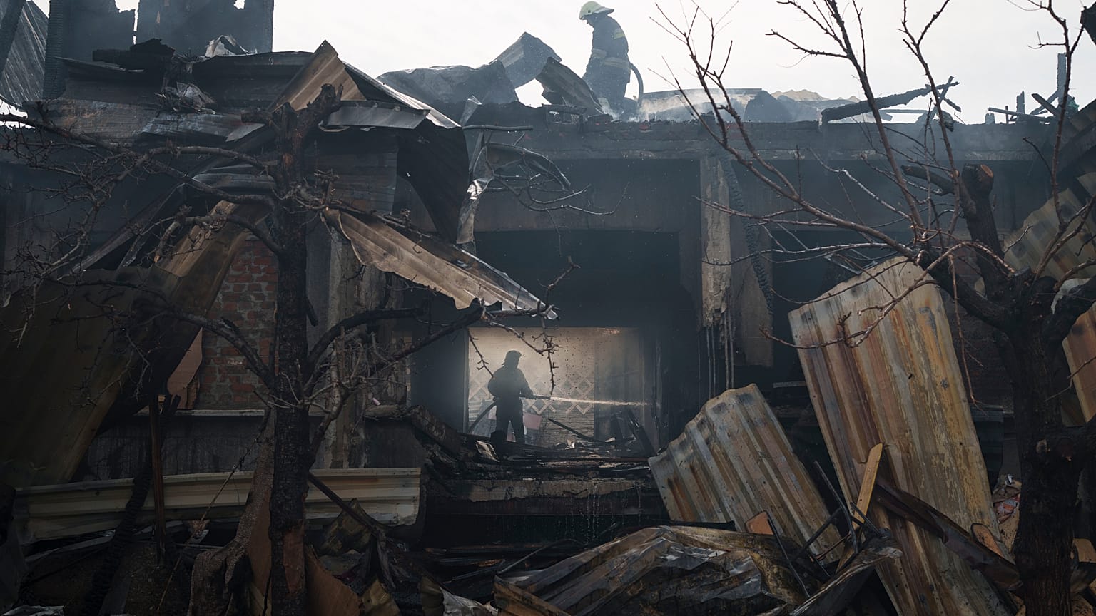 Firefighters work to extinguish a fire at a house after a Russian attack in Kharkiv, Ukraine, Monday, April 11, 2022.