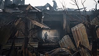 Firefighters work to extinguish a fire at a house after a Russian attack in Kharkiv, Ukraine, Monday, April 11, 2022.