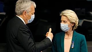 European Commissioner for Justice Didier Reynders (L) speaks with European Commission President Ursula von der Leyen.