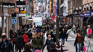 People visit one of Stockholm's busiest shopping streets on February 4, 2022.