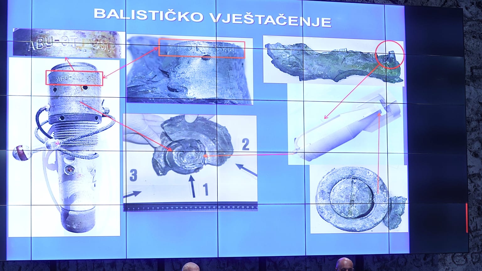 Photos of fragments of a bomb are displayed above officials in Zagreb.
