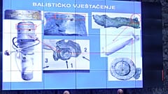 Photos of fragments of a bomb are displayed above officials in Zagreb.