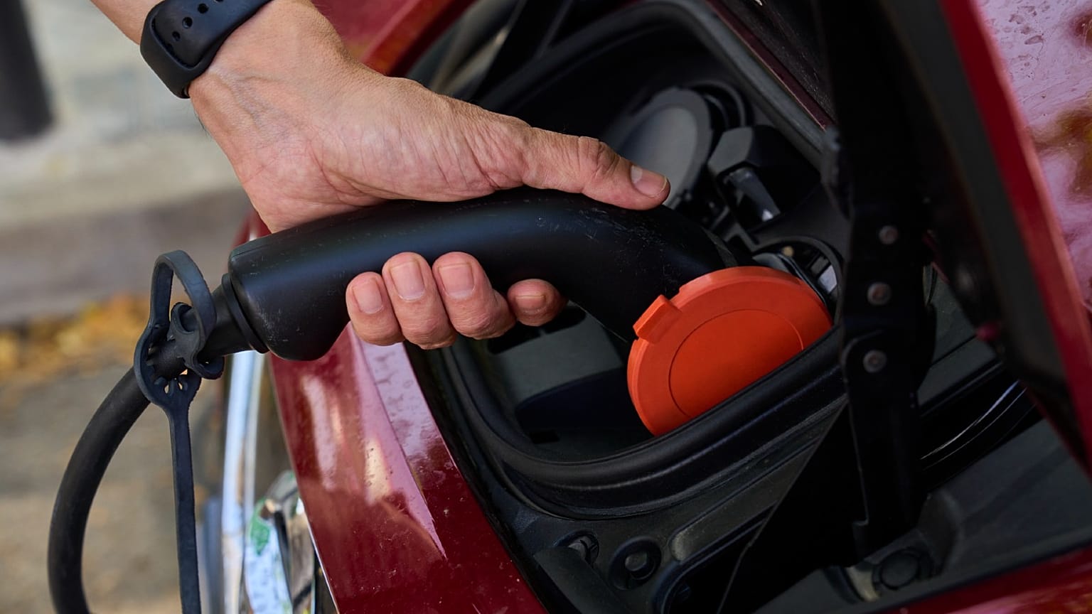 A man charges his electric car at an electrical charging point in Rivas Vaciamadrid, Spain, June 15, 2021.