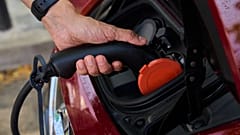 A man charges his electric car at an electrical charging point in Rivas Vaciamadrid, Spain, June 15, 2021.
