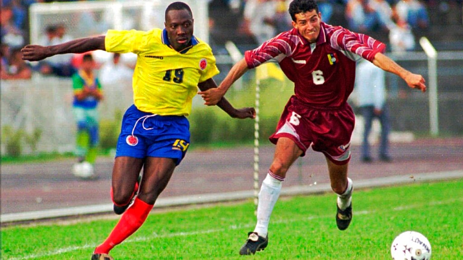 Colombian player Freddy Rincon, left, fights for the ball with Elvis Martinez of Venezuela during a qualifying France '98 game in San Cristobal, Venezuela