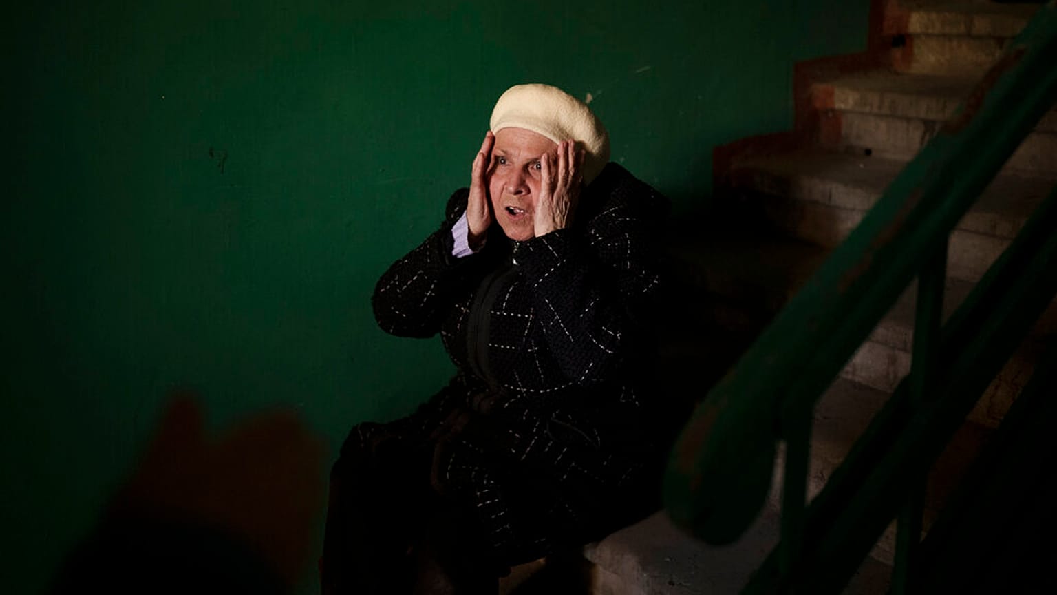 A woman reacts next to the body of a 15-year-old boy killed during a Russian attack in Kharkiv, Ukraine, Friday, April 15, 2022.