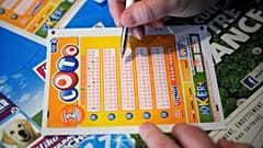 A French gambler fills in a lottery ticket of Super Loto.