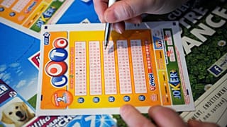 A French gambler fills in a lottery ticket of Super Loto.