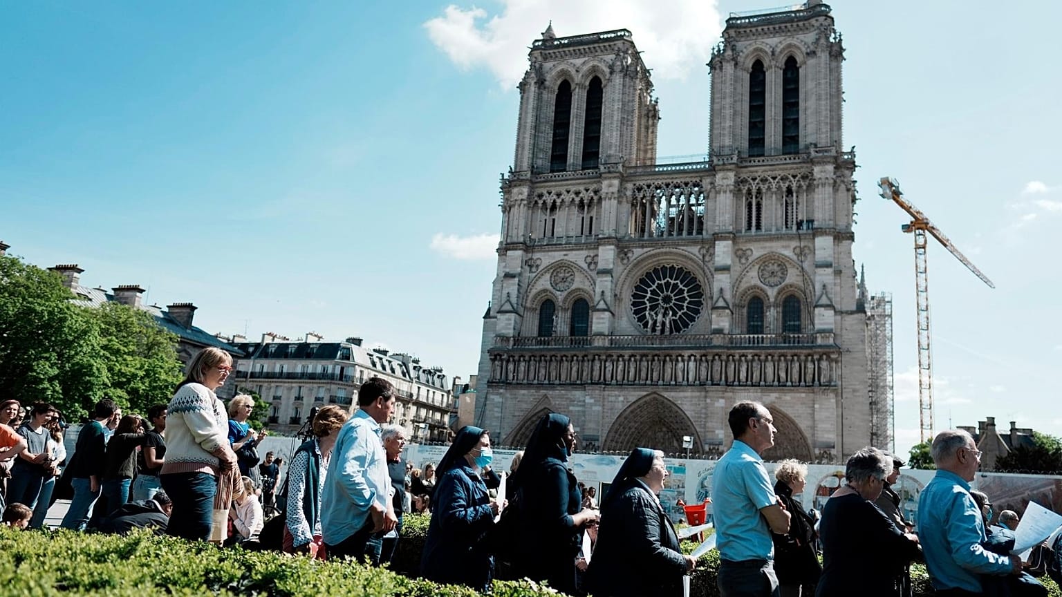 The faithful attend the Way of the Cross ceremony as part of the Holy Easter celebration, on the forecourt of Notre Dame Cathedral, in Paris, Friday, April 15, 2022