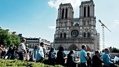 The faithful attend the Way of the Cross ceremony as part of the Holy Easter celebration, on the forecourt of Notre Dame Cathedral, in Paris, Friday, April 15, 2022