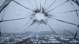 A hospital window is cracked from shelling in Mariupol.
