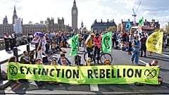 Demonstrators take part in an Extinction Rebellion protest on Westminster Bridge in London, Friday, April 15, 2022. 