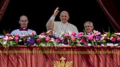 Pope Francis, centre, waves to the crowd after the traditional 'Urbi et Orbi' blessing after Easter Sunday mass in St. Peter's Square at the Vatican, Sunday, April 17, 2022.