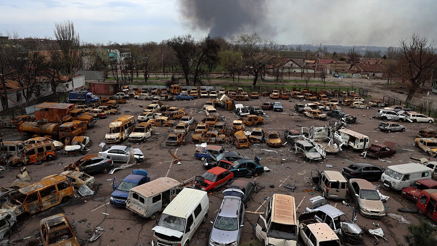 Damaged and burned vehicles are seen at a destroyed part of a plant in an area controlled by Russian-backed separatist forces in Mariupol