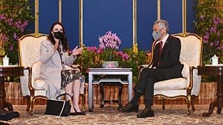 New Zealand's Prime Minister Jacinda Ardern (L) gestures as she talks with her Singaporean counterpart Lee Hsien Loong during a meeting at the Istana presidential palace. 