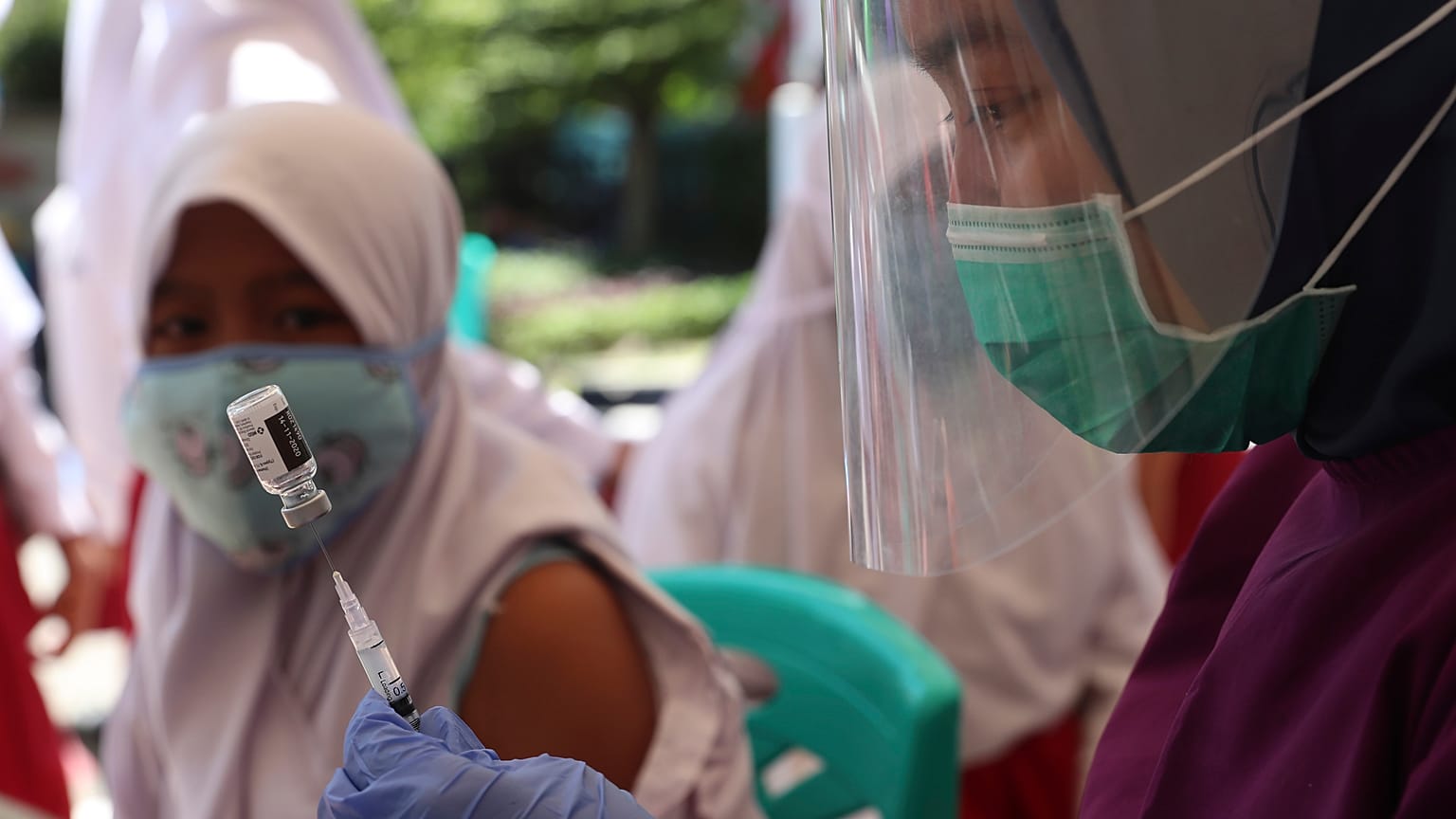 A health workers prepares an HPV vaccine shot for a student in Jakarta, Indonesia