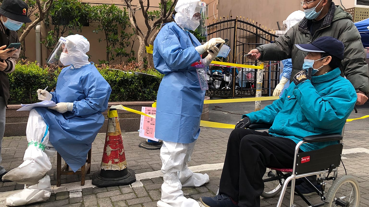 FILE - Workers in protective gear register residents for COVID testing in the Jingan district of western Shanghai, China, Friday, April 1, 2022
