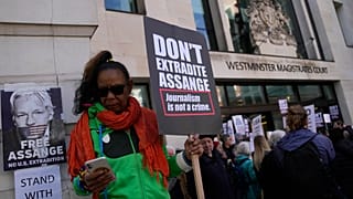 Wikileaks founder Julian Assange supporters hold placards as they gather outside Westminster Magistrates court In London, Wednesday, April 20, 2022