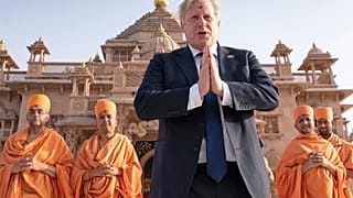 Boris Johnson walks with sadhus, Hindu holymen, as he visits the Swaminarayan Akshardham temple in Gandhinagar, Ahmedabad, part of his two-day trip to India, April 21, 2022.