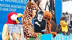 With a cardboard cutout of International Monetary Fund Managing Director Kristalina Georgieva, costumed environmental activists protested in front of the IMF building.