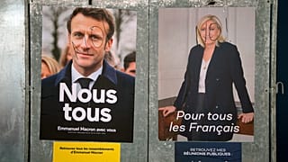 Advertisements featuring both candidates in the French presidential runoff, Emmanuel Macron and Marine Le Pen.