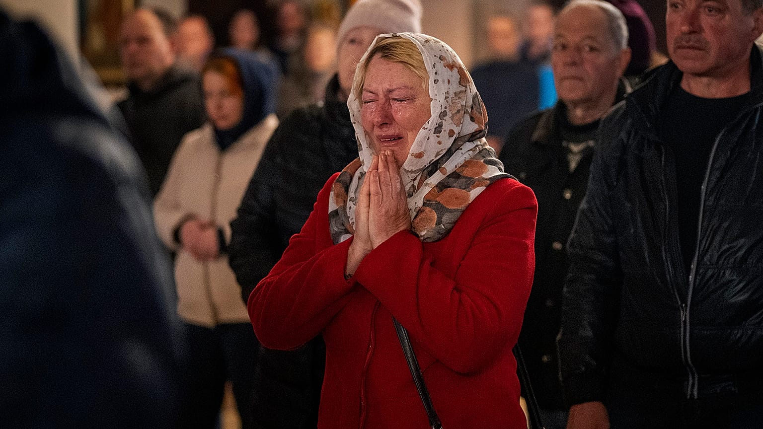 Olga Zhovtobrukh, 55, cries during an Easter religious service celebrated at a church in Bucha on 24 April 2022