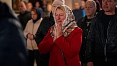 Olga Zhovtobrukh, 55, cries during an Easter religious service celebrated at a church in Bucha on 24 April 2022