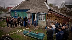Relatives of Mykola Moroz, 47, gather during a funeral service at his home at the Ozera village, near Bucha, Ukraine, on Tuesday, April 26, 2022.