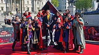 Actor Benedict Cumberbatch poses for a photocall with cosplayers in London ahead of the release of 'Doctor Strange in the Multiverse of Madness'