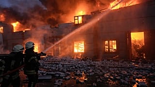 Ukrainian firefighters tackle a blaze on the outskirts of Mariupol after the Russian airstrike on March 16 that destroyed the city's Drama Theatre