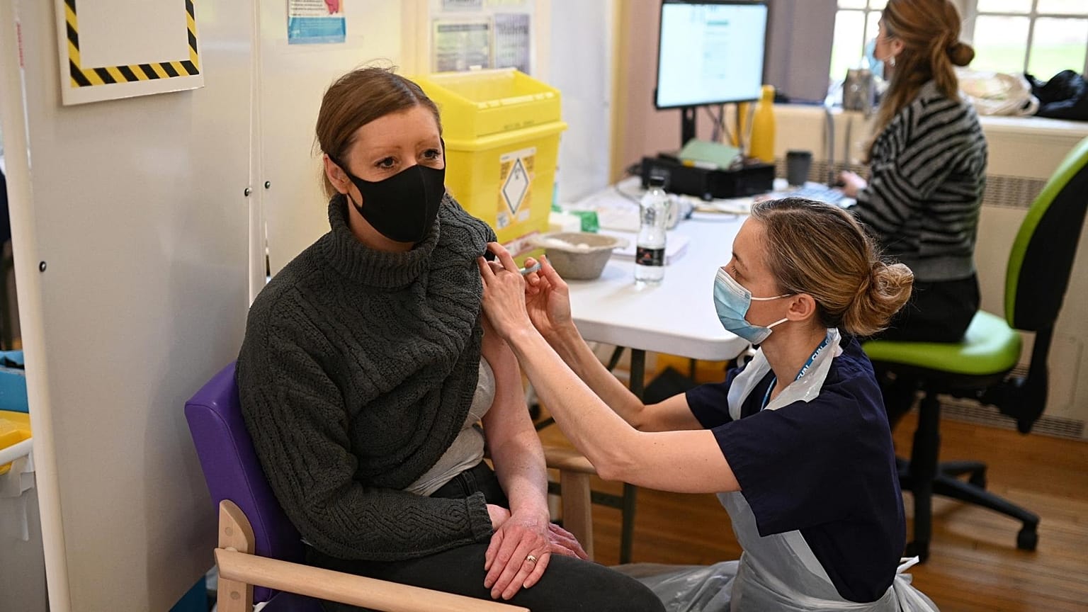 A woman receives a dose of the Moderna Covid-19 vaccine at Babington Hospital in Belper, UK. 