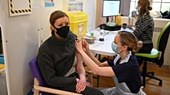 A woman receives a dose of the Moderna Covid-19 vaccine at Babington Hospital in Belper, UK. 